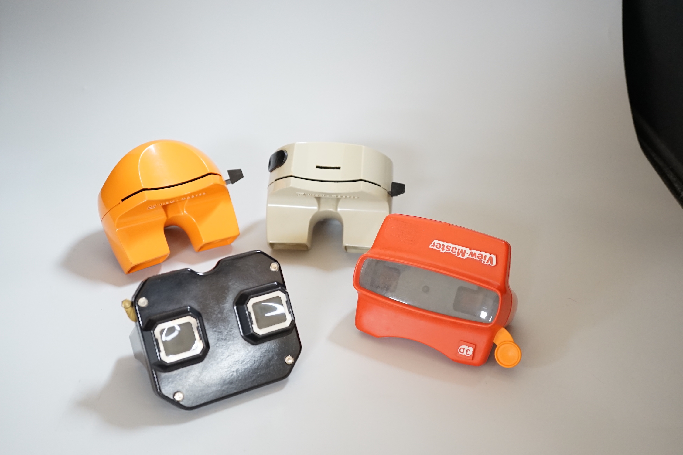 Fifteen View-Master viewers, including five ‘Model K’ viewers, in red and orange, together with a small quantity of reels with subjects including classic stories and cartoons, and a Library Box in its original outer card